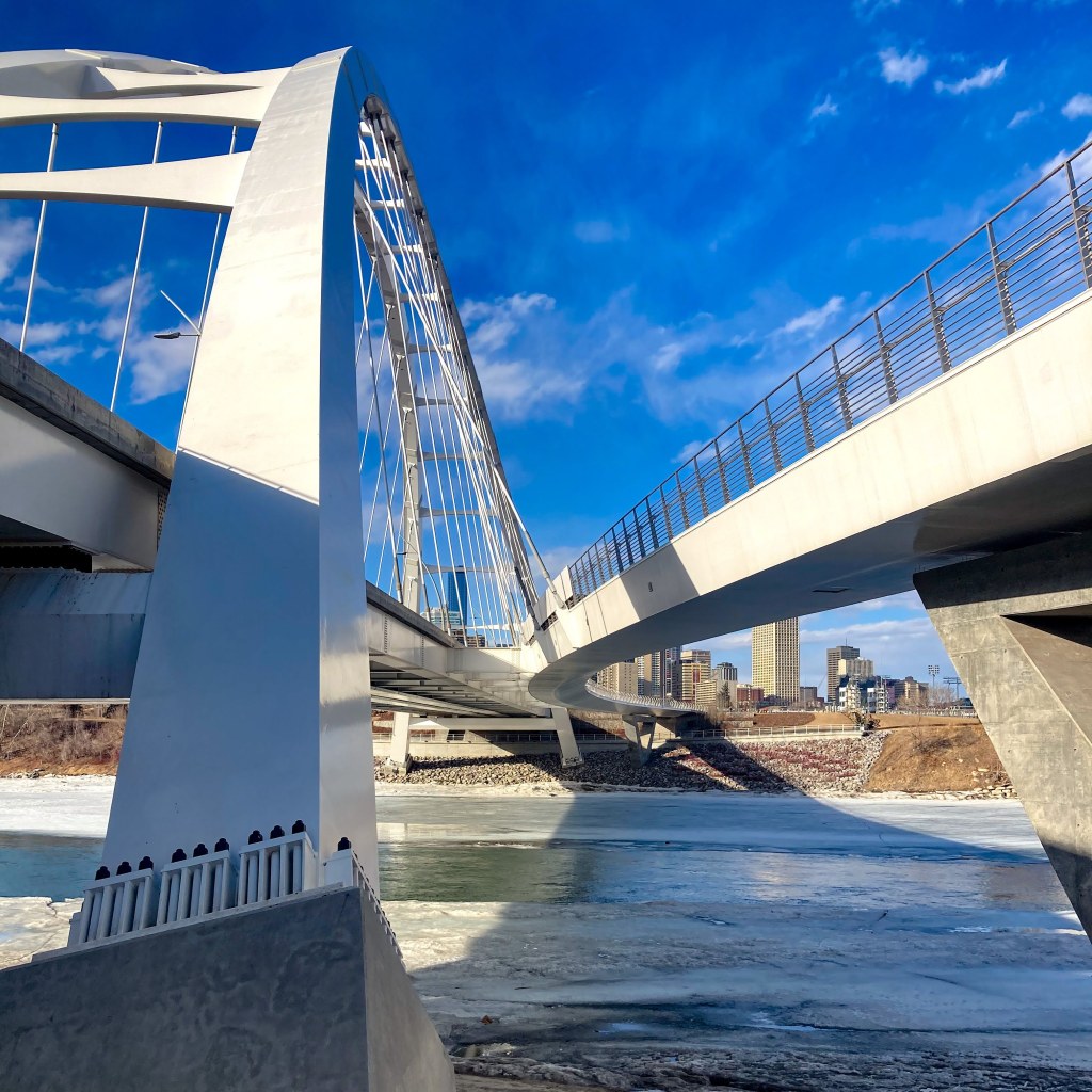 an upward view of the Walterdale bridge from the path that runs under the south side